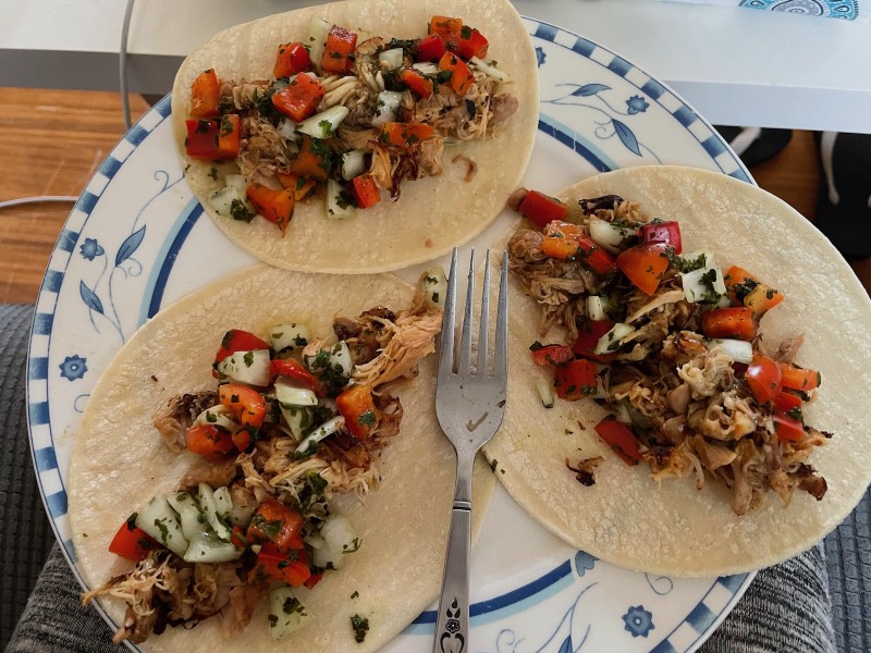 a plate of chicken tacos, lying open