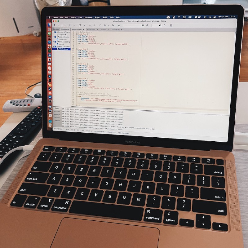 a rose gold MacBook Air with an IDE open
