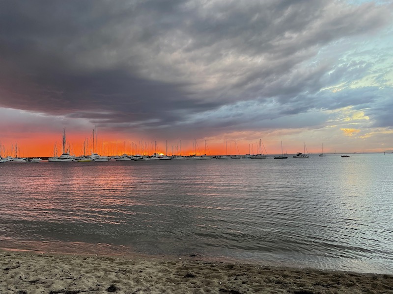 a view from a little later on the beach. the grey cloud is now larger and more dominant; on the horizon is a darker pink, almost red
