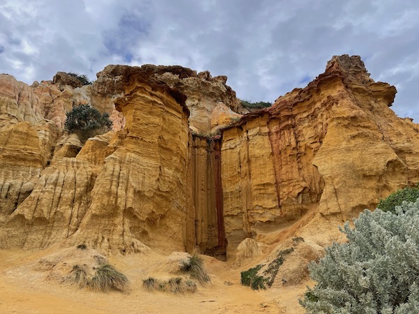 another part of the cliffs seen front-on, with a sharp vertical alcove within